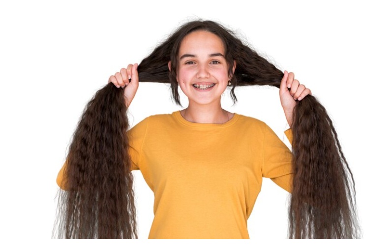 A woman experiencing hair growth as a benefit of beeswax for hair